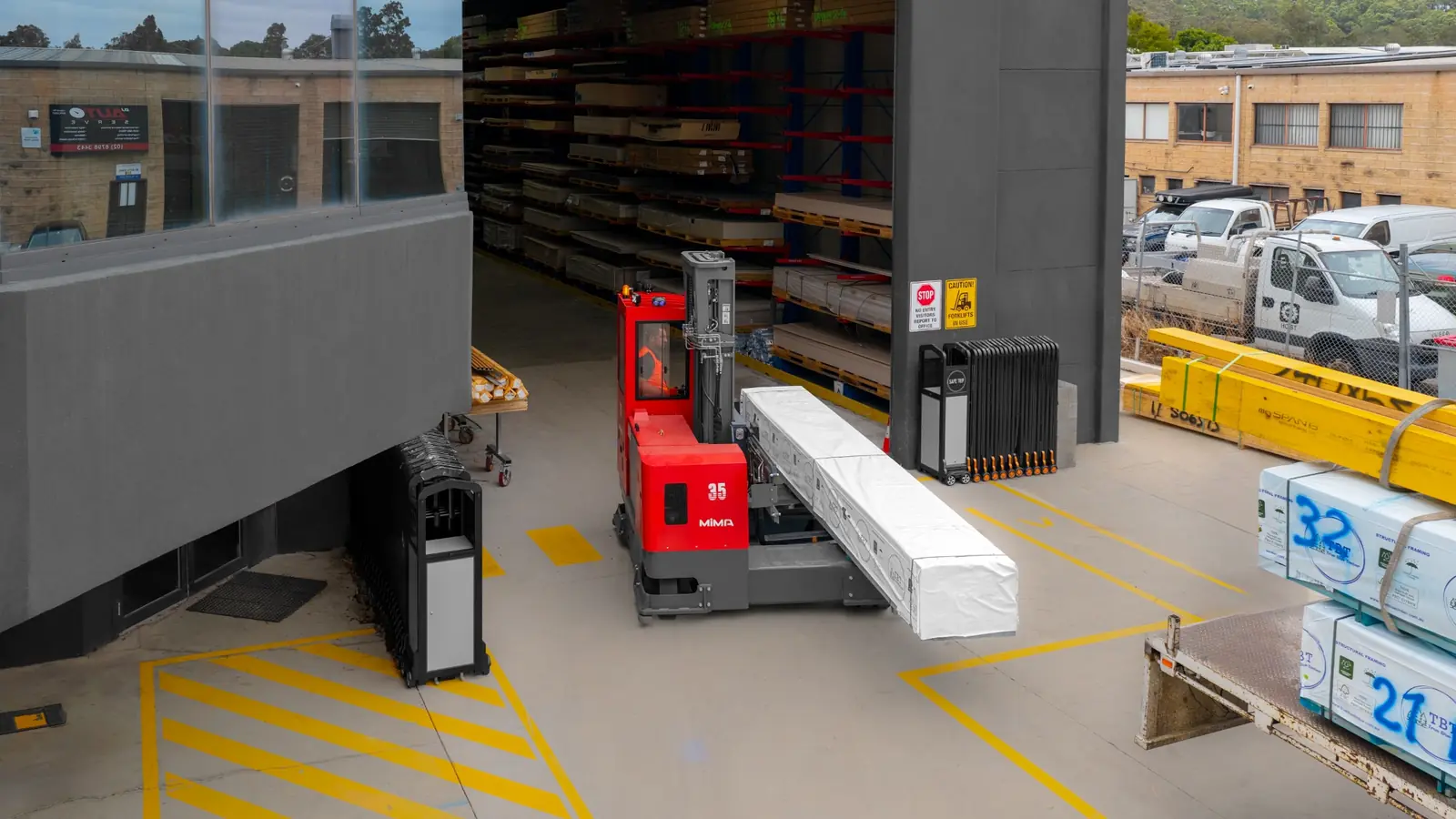 MiMA multi-directional forklift moving a long load between indoor and outdoor working areas