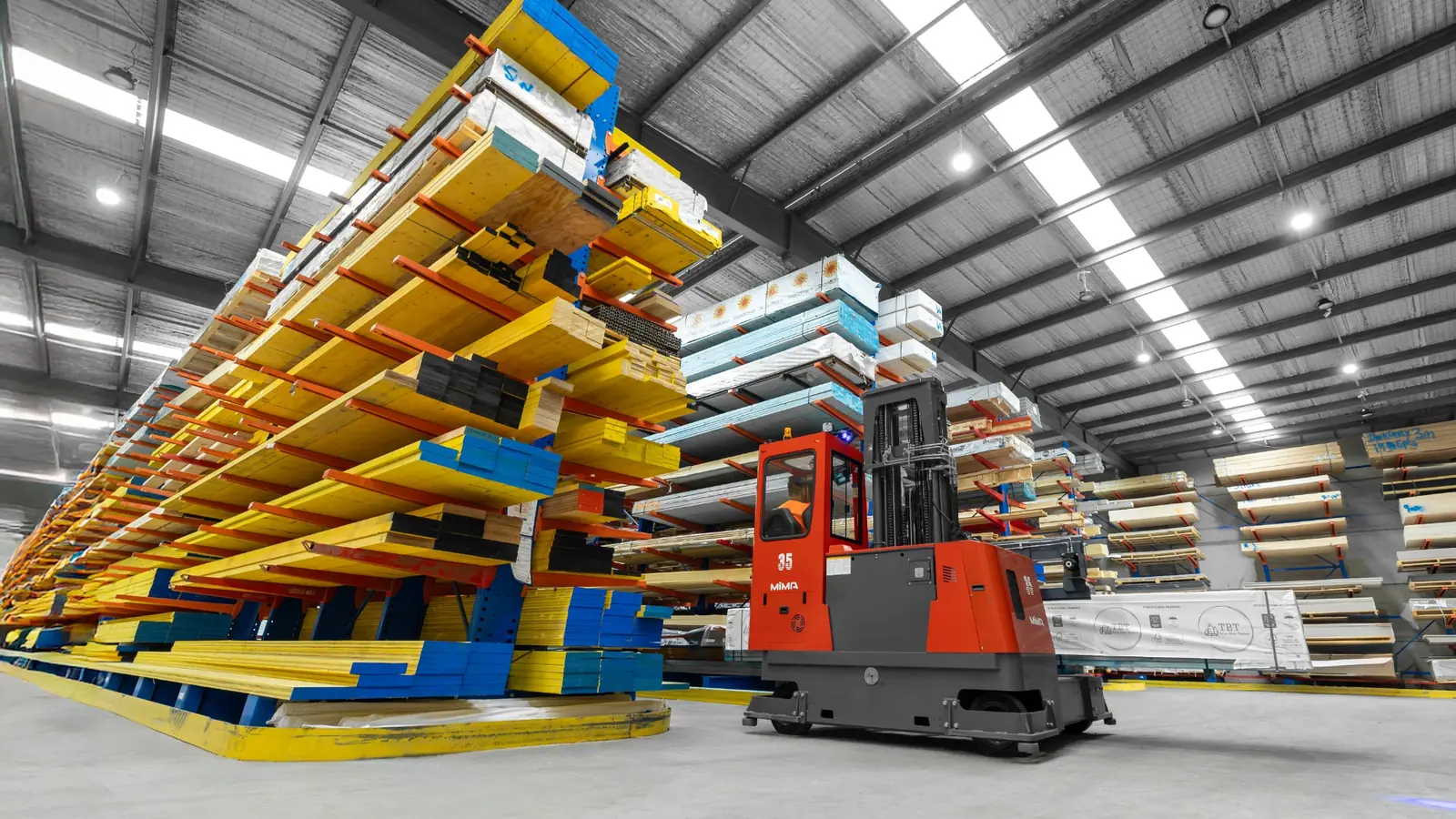MiMA multi-directional forklift handling long materials inside an industrial warehouse